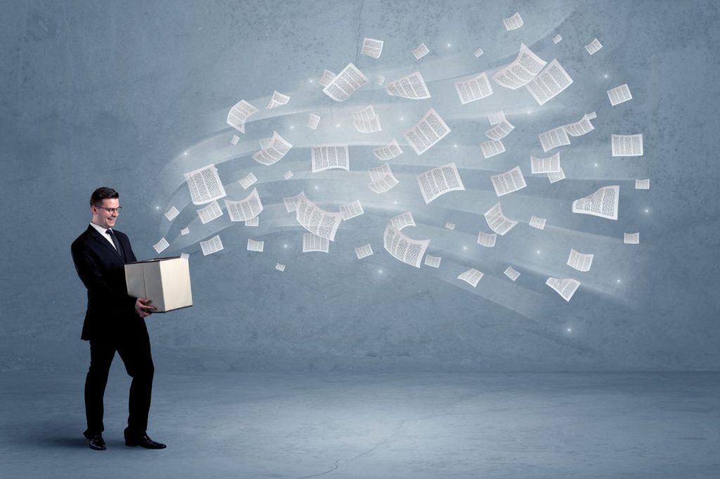 man with paper of information overload from the box